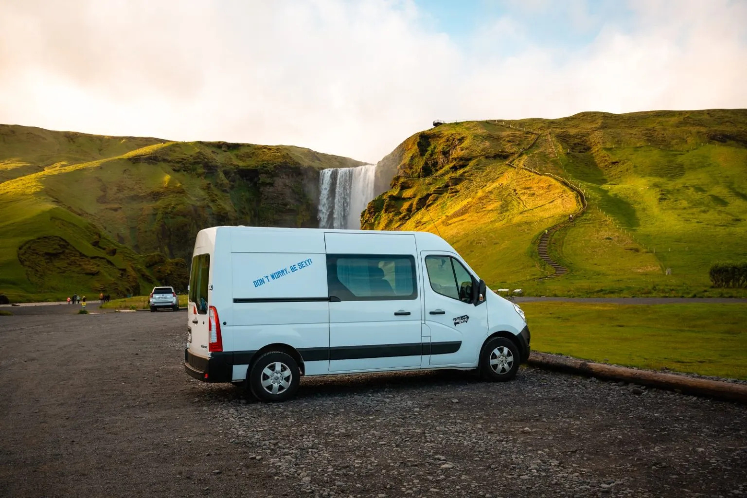 Campervan parked near an Iceland waterfall, showing how simple it is to explore iconic spots without needing a 4x4