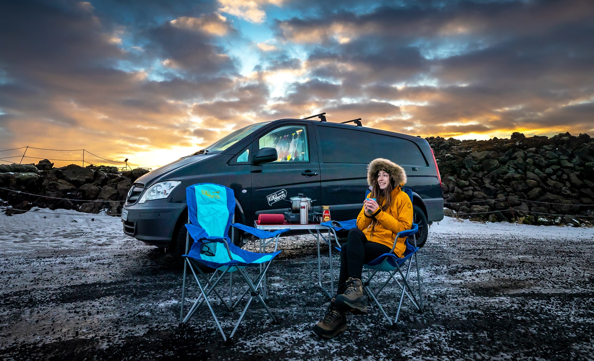 Travelers enjoying campervan life in Iceland with outdoor setup, illustrating real road trip experience