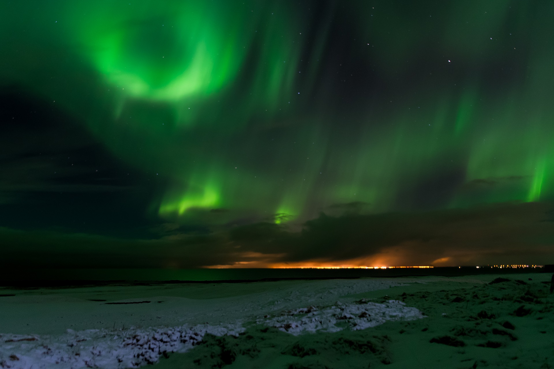 Aurora with light pollution in Iceland