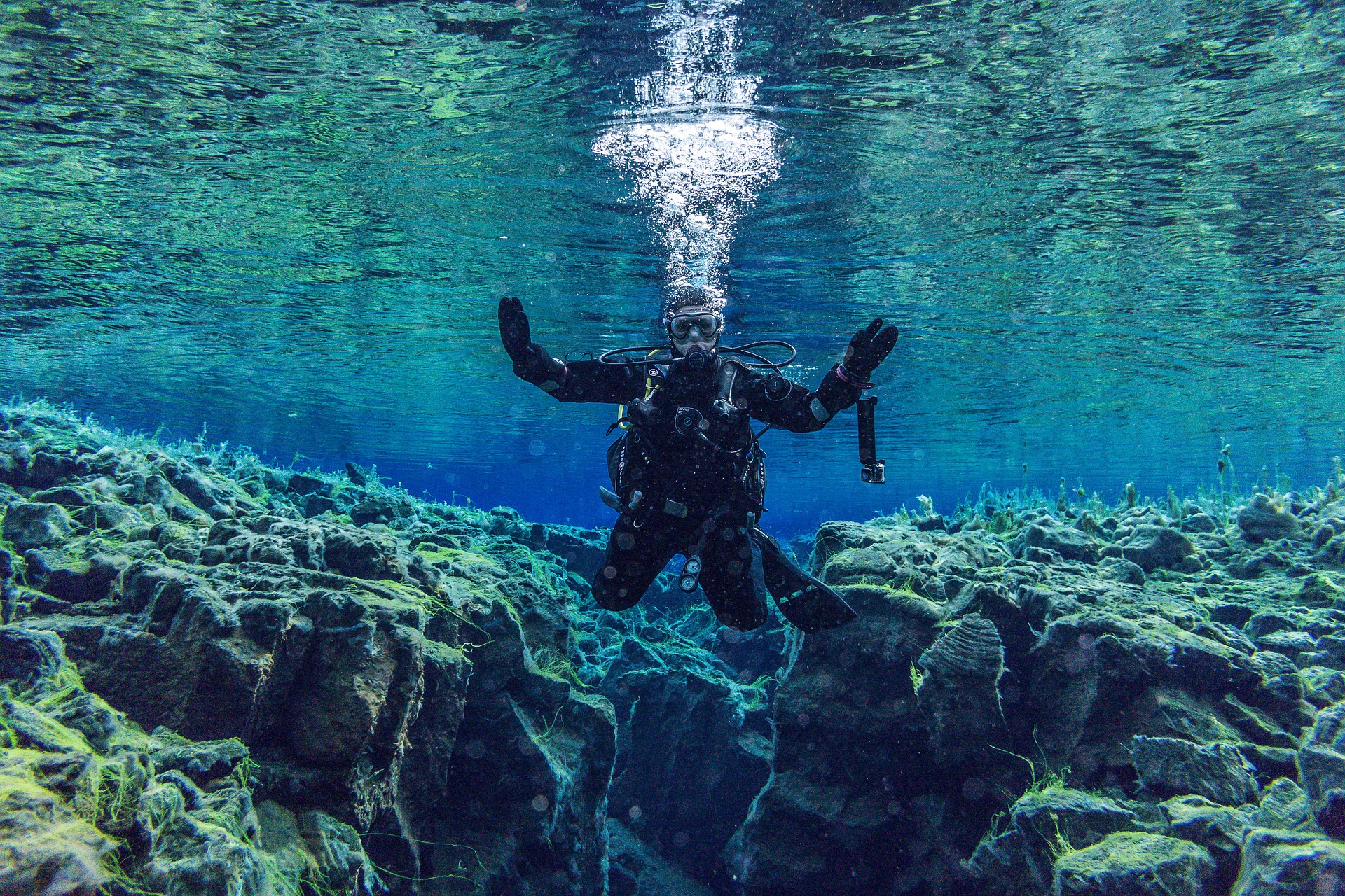 Man diving in Silfra, Iceland