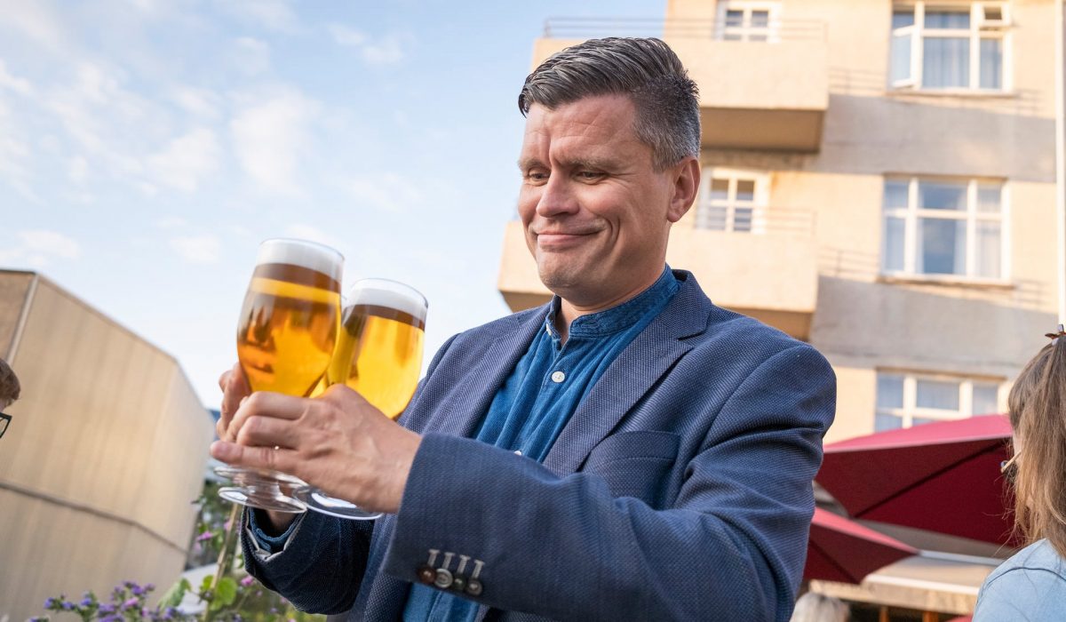 A man holding beers with a proud smile in Reykjavík – Iceland’s happy hour just got a little happier.