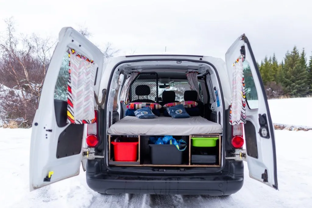Inside a campervan in Iceland with bed and storage setup, proving your hotel just got smaller and smarter