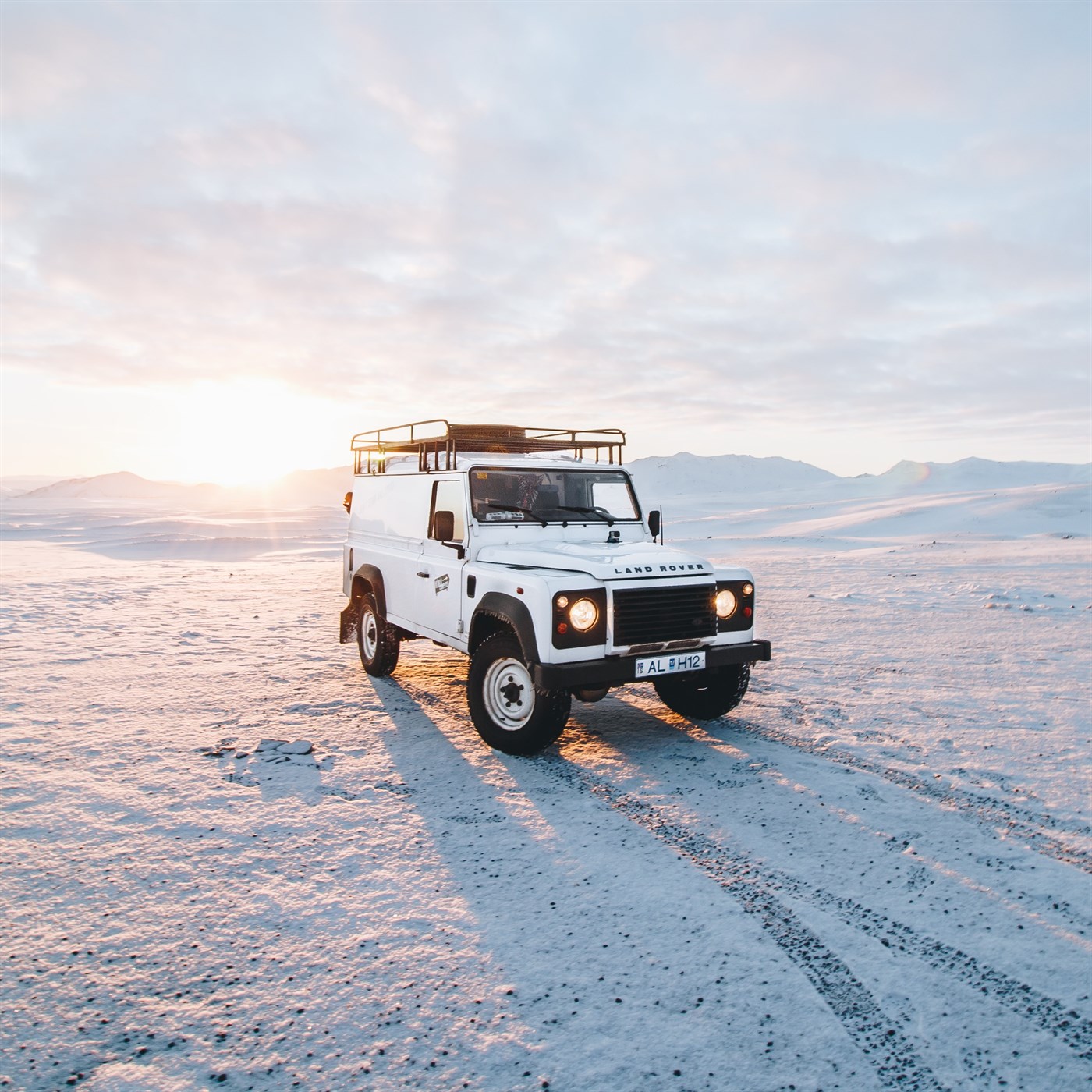 A 4x4 vehicle equipped with a roof tent, ideal for accessing remote areas and enjoying elevated camping.