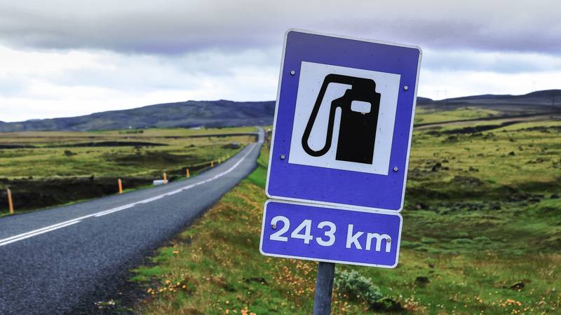 Road sign in Iceland showing long distance until the next gas station, important for fuel planning during remote drives.