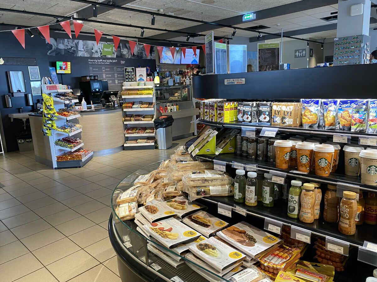Food and snack area inside an Iceland gas station, showing how fuel stops often double as mini supermarkets during road trips.