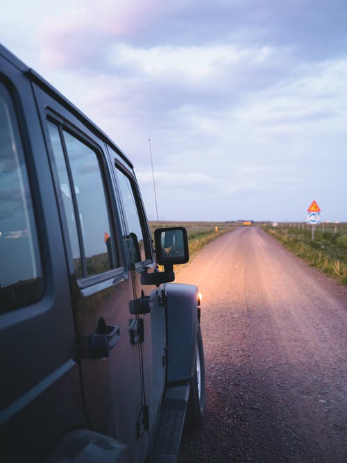A rugged 4x4 tackling Iceland's challenging terrain, navigating through the wild, snow-covered landscapes, showcasing the island's tough and untamed nature