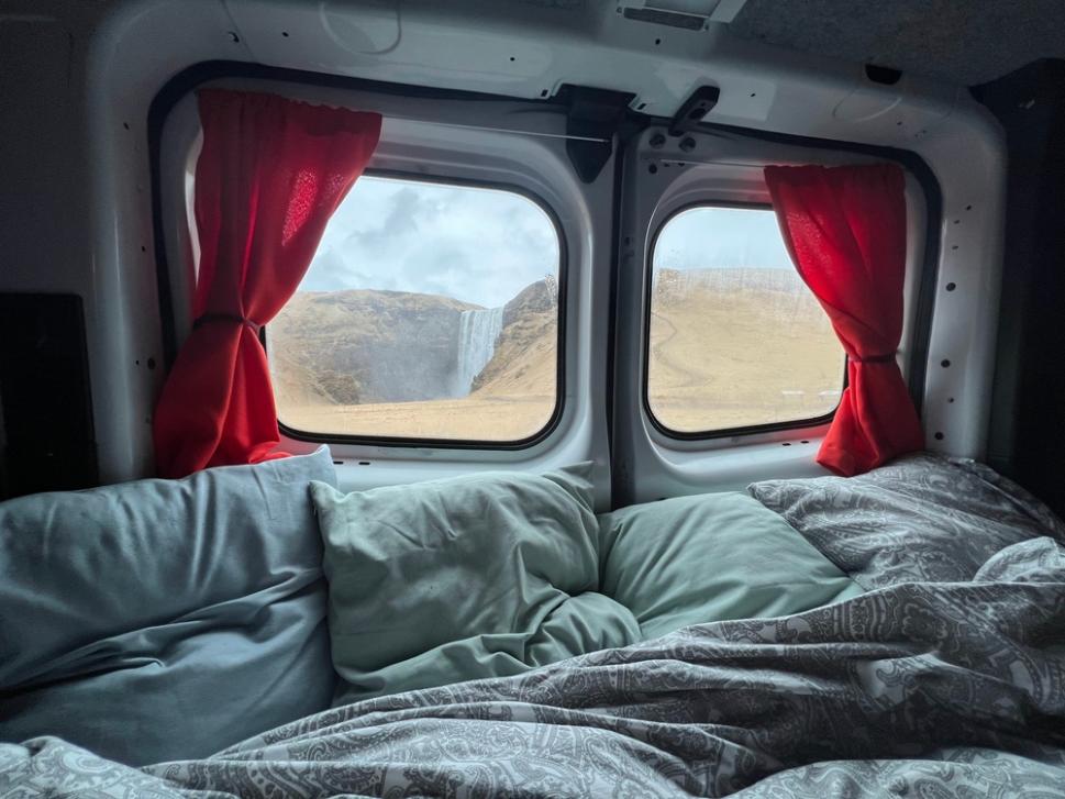 Comfortable campervan sleeping setup prepared for cold nights during an Iceland campervan trip.