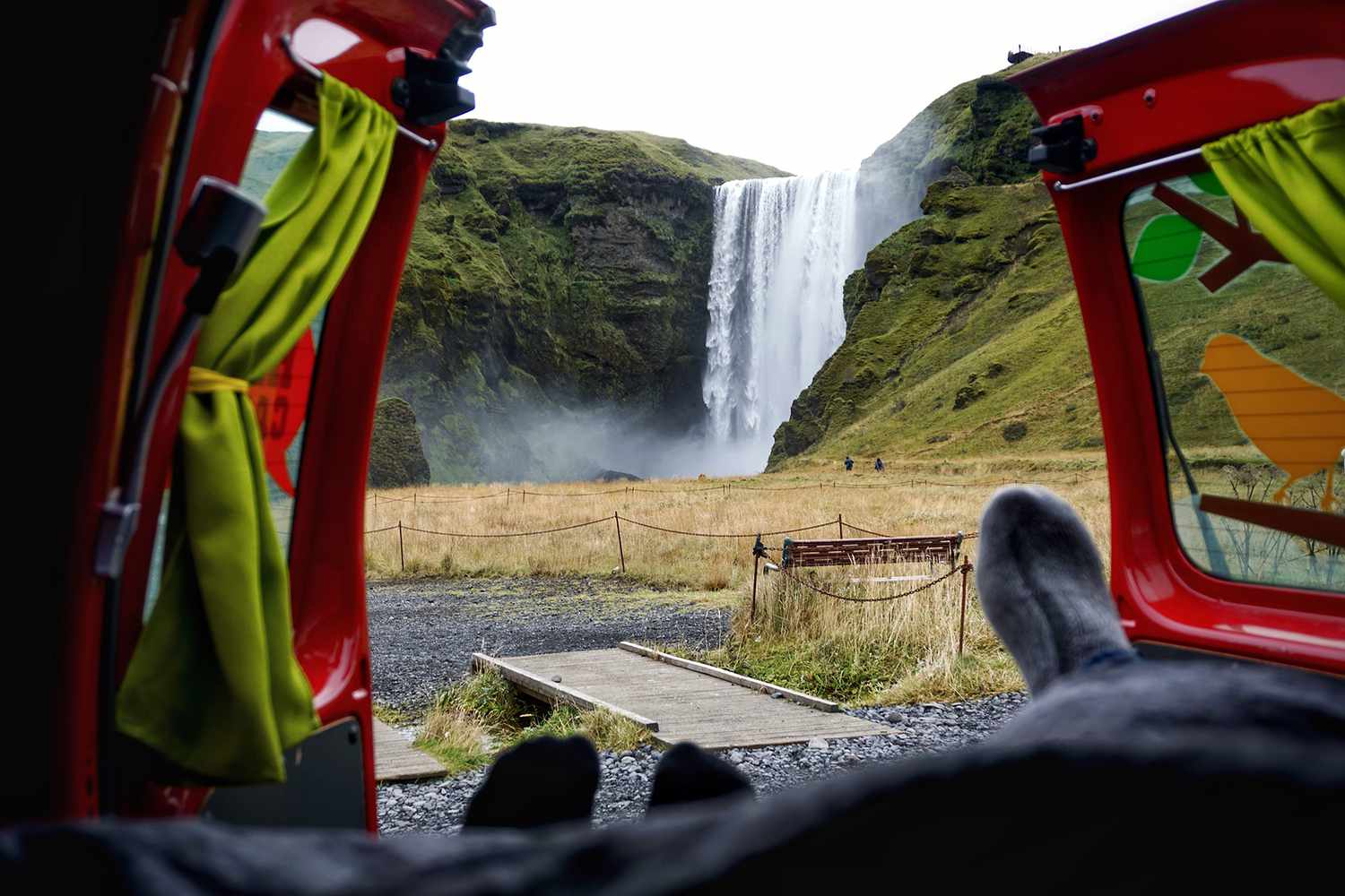 View from inside a campervan parked near Skogafoss waterfall, showing the flexibility of campervan travel in Iceland.