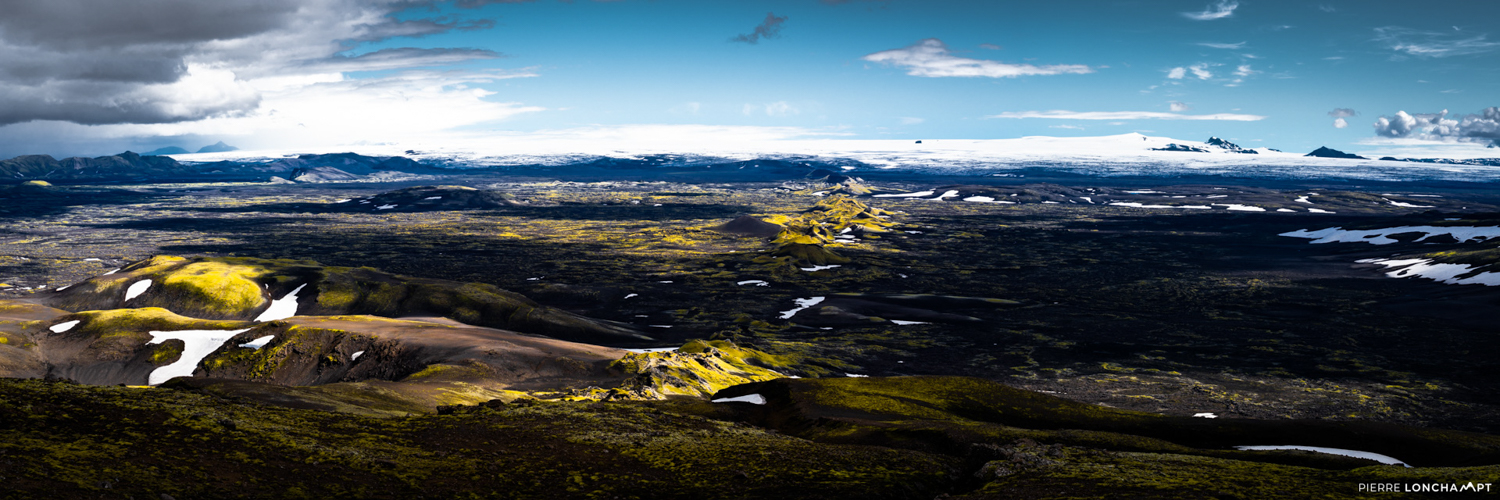 A panoramic view of Iceland’s Highlands, showcasing remote lakes, rugged terrain, and untouched beauty on an unforgettable road trip