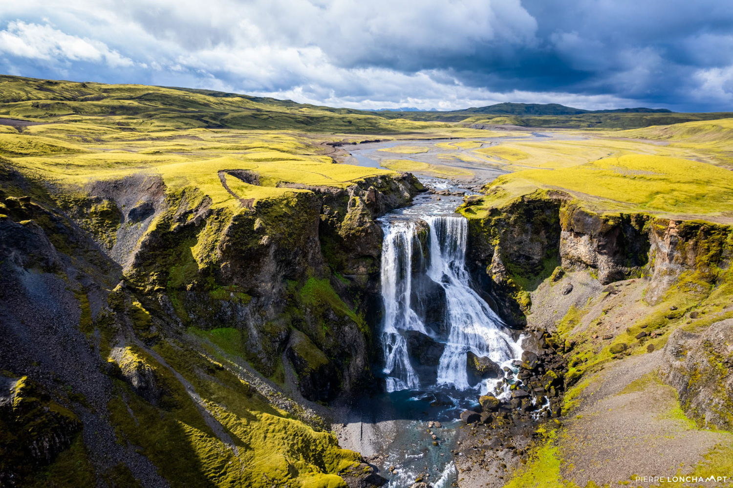 The majestic Fagrifoss waterfall cascading through Iceland’s lush landscapes, an unforgettable stop on your road trip adventure