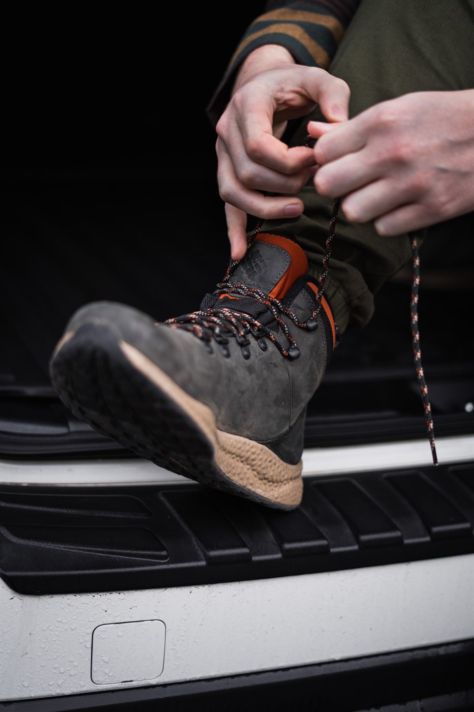 Tightening up hiking boots before hitting the trails – a classic campervan moment before exploring Iceland’s rugged terrain.