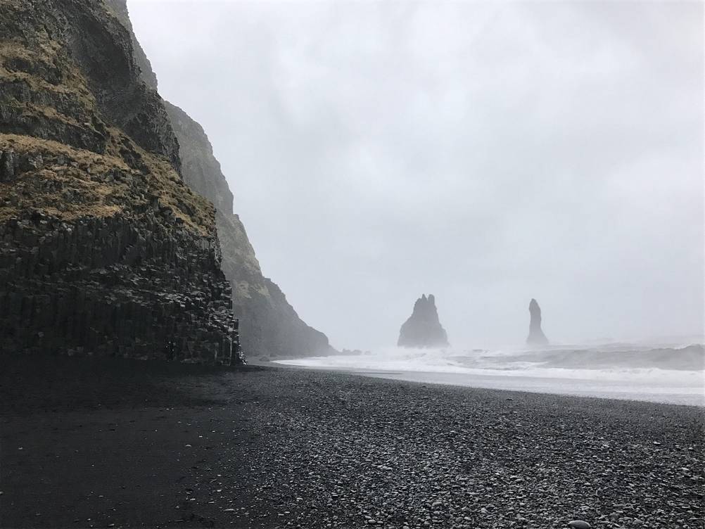 Reynisfjara black sand beach Reynisfjara, fogg, black sand and cloud