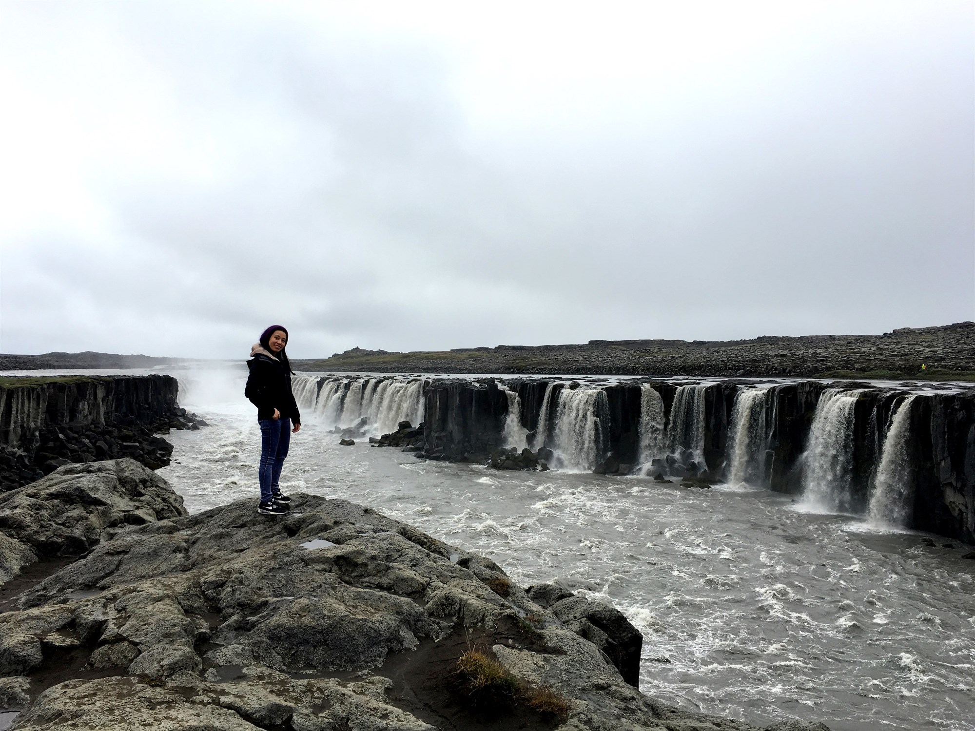 woman in front of Selfoss Waterfall in Iceland