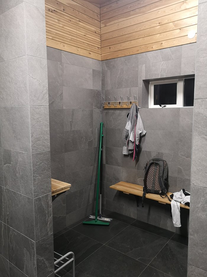 Modern shower and changing room at an Iceland campsite, offering clean facilities for campervan travelers.