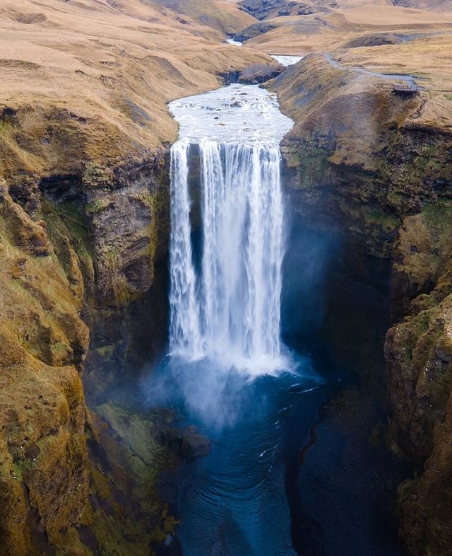 The powerful Skógafoss waterfall along the Fimmvörðuháls hiking trail, where cascading water meets rugged Icelandic landscapes