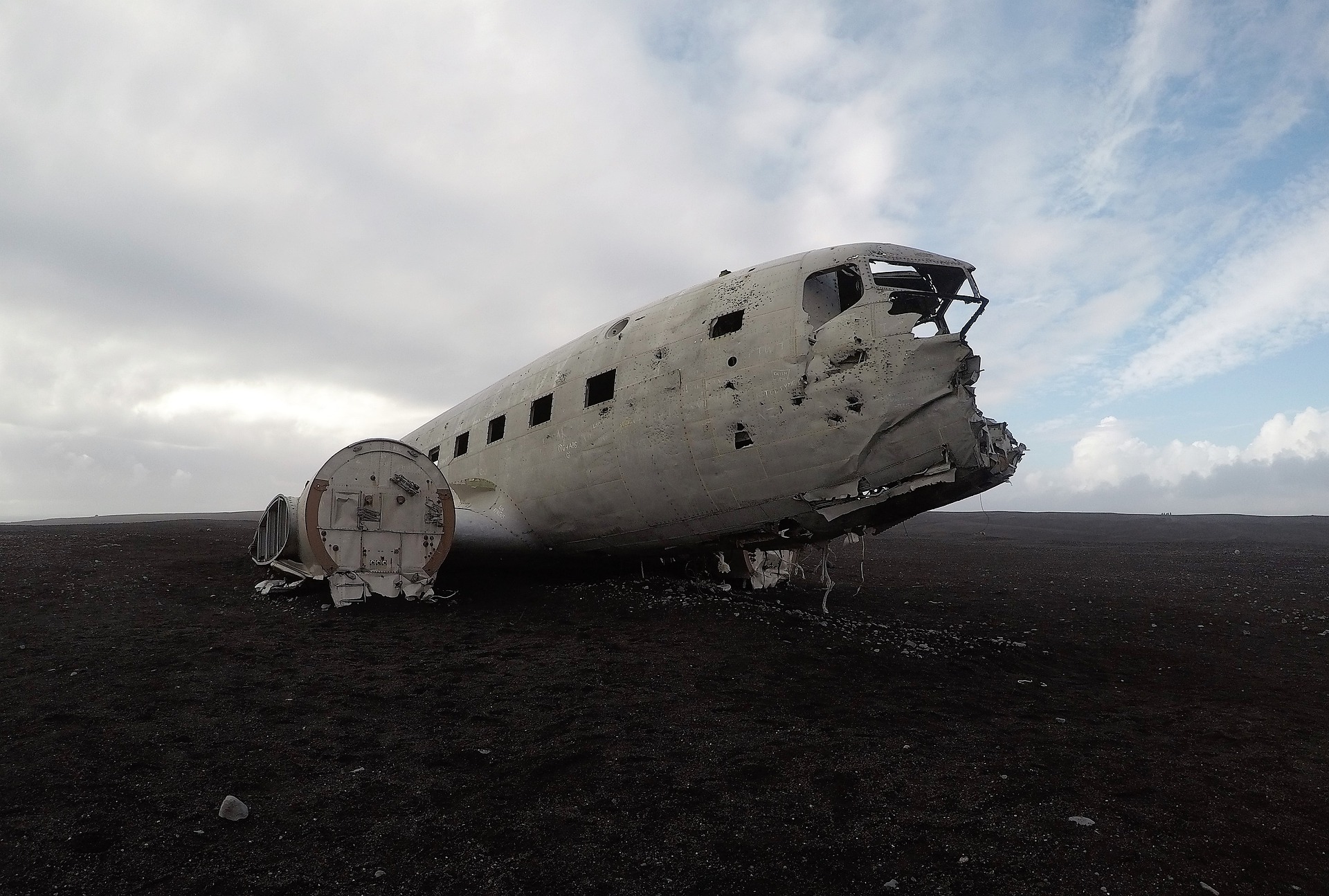 Solheimasandur plane wreck in Iceland, blue and grey sky, black sand