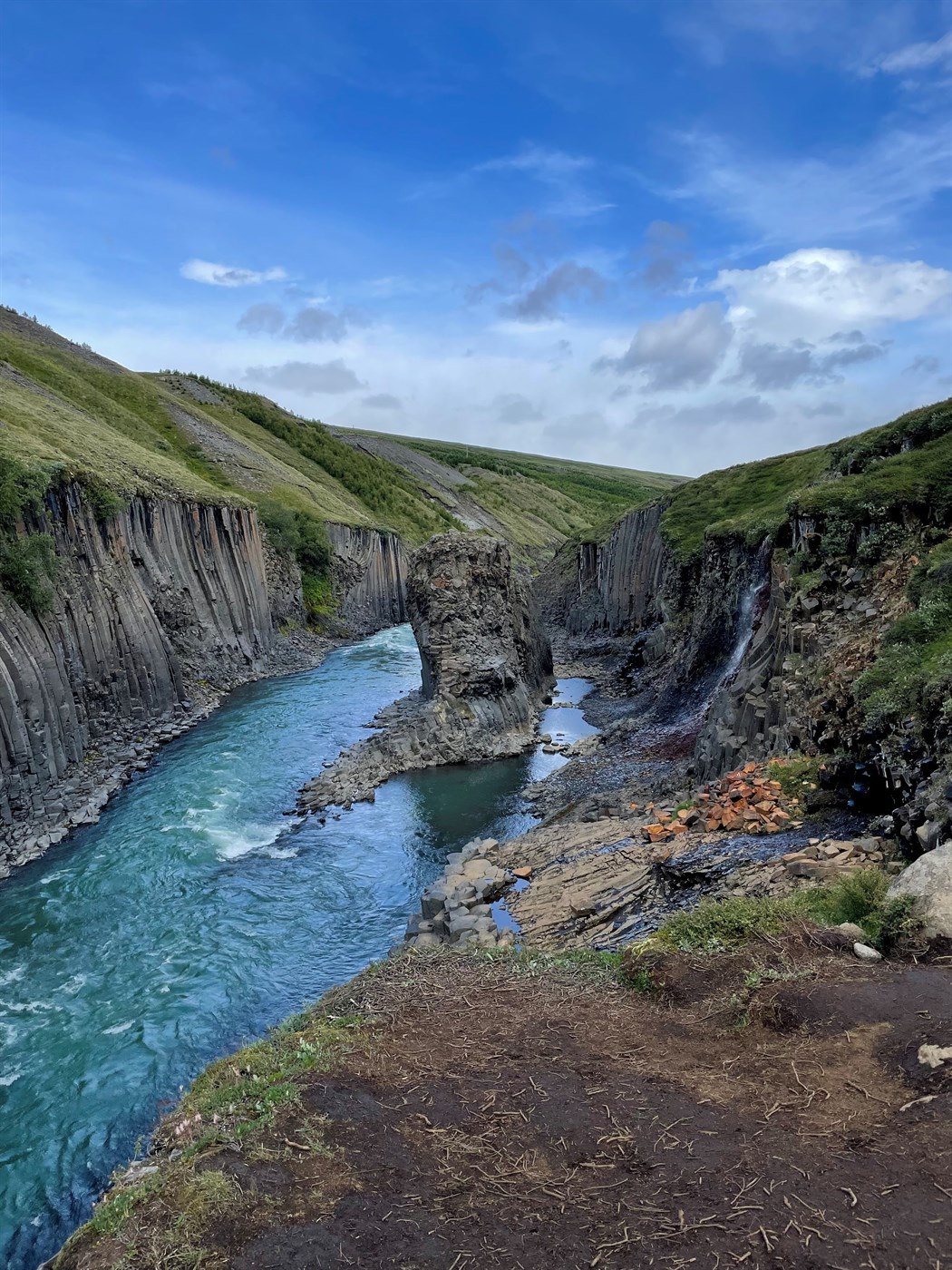 Hiking in Iceland leads you to marvels like Stuðlagil Canyon, where dramatic basalt formations meet serene turquoise waters. A top hiking destination!